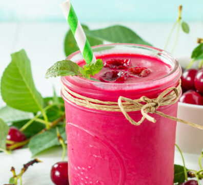 Healthy cherry cordial detox smoothie in a glass with cocoa and cherries