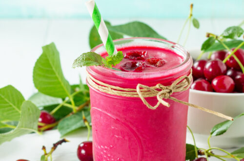 Healthy cherry cordial detox smoothie in a glass with cocoa and cherries